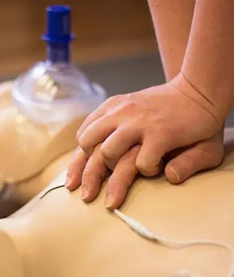 Hands Performing CPR on a Training Manikin in Los Angeles, CA